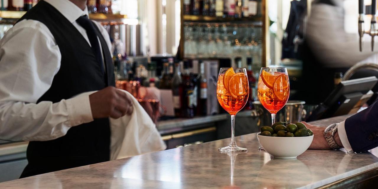 Hotel Diplomat Stockholm Ngoại thất bức ảnh A bartender wiping down the bar
